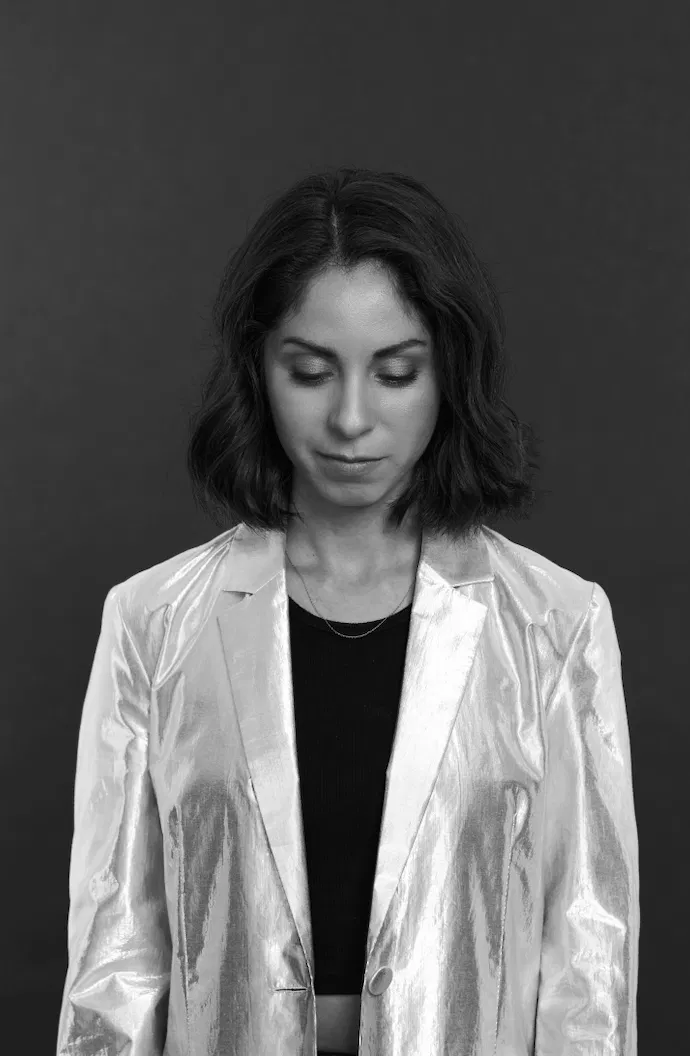 Black-and-white portrait of JIJI in a silver jacket